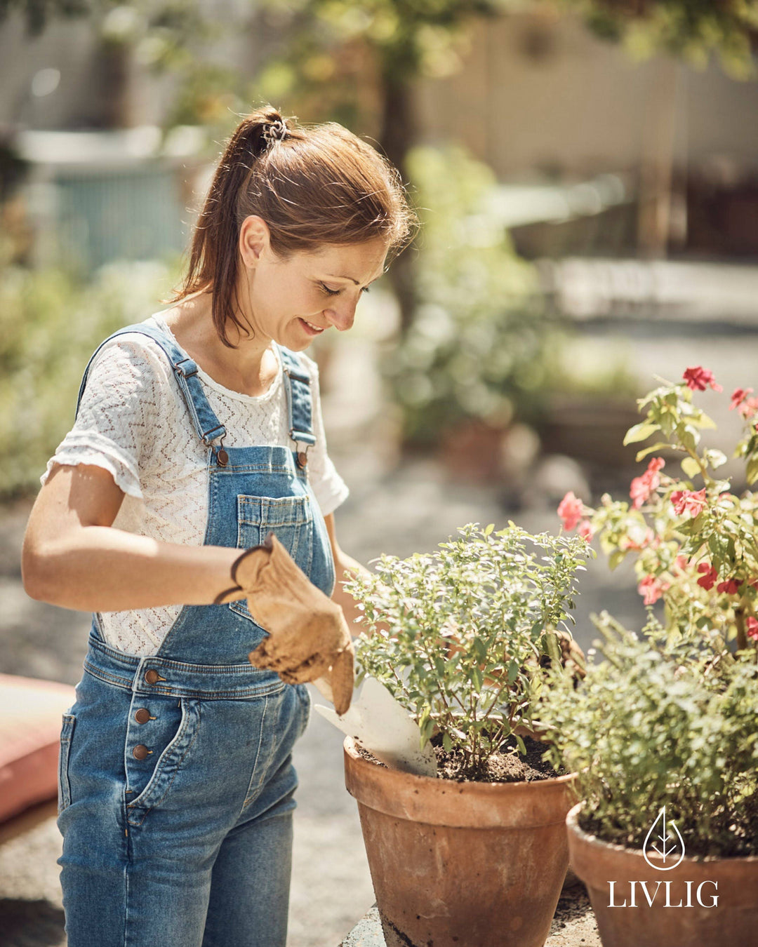 a woman is working in a garden with potted plants