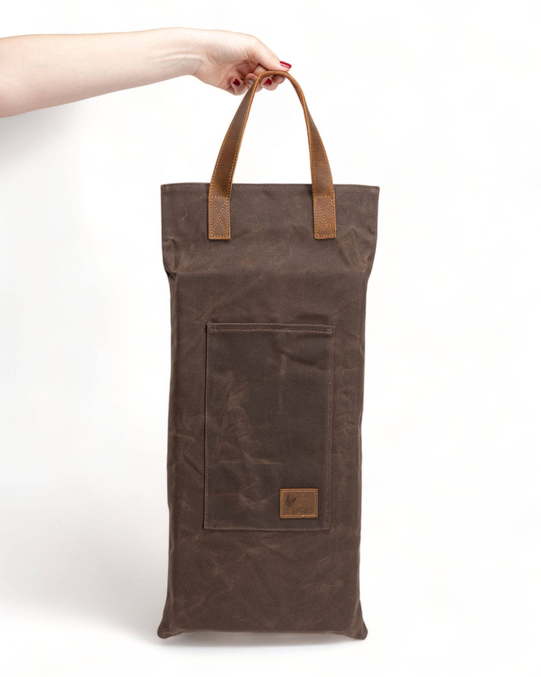 a person holding a brown bag with a brown handle