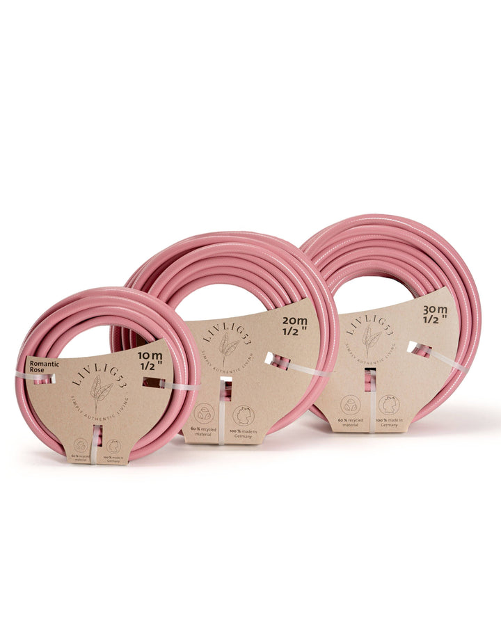 a set of three pink hoses sitting next to each other