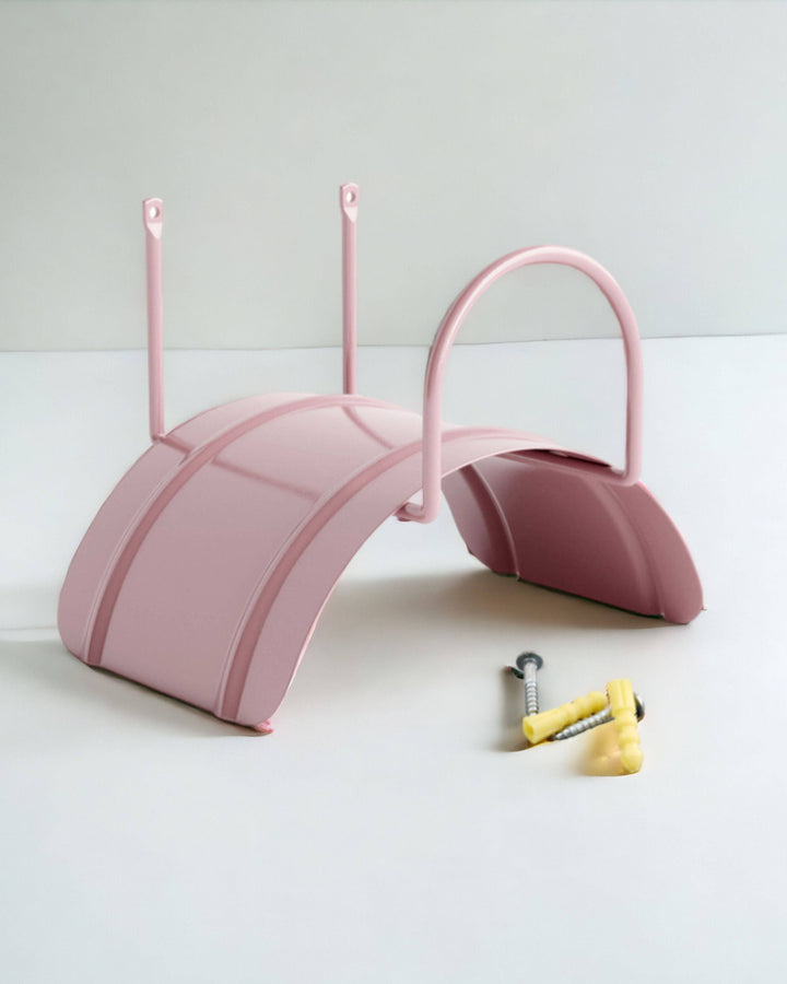 a pair of pink umbrellas sitting on top of a white table