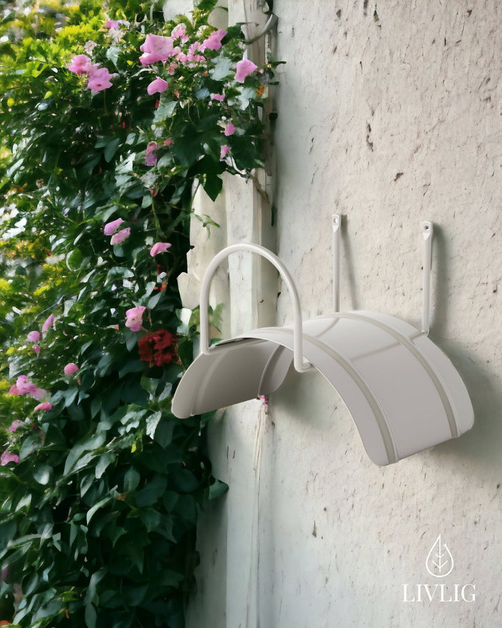 a white wall mounted umbrella holder next to a white wall