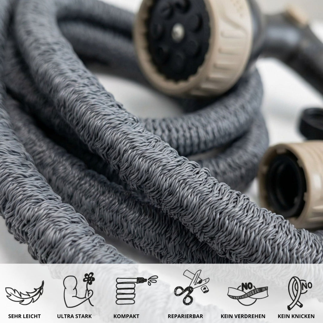 Gray flexible garden hose with braided texture and beige spray nozzle, coiled close-up view