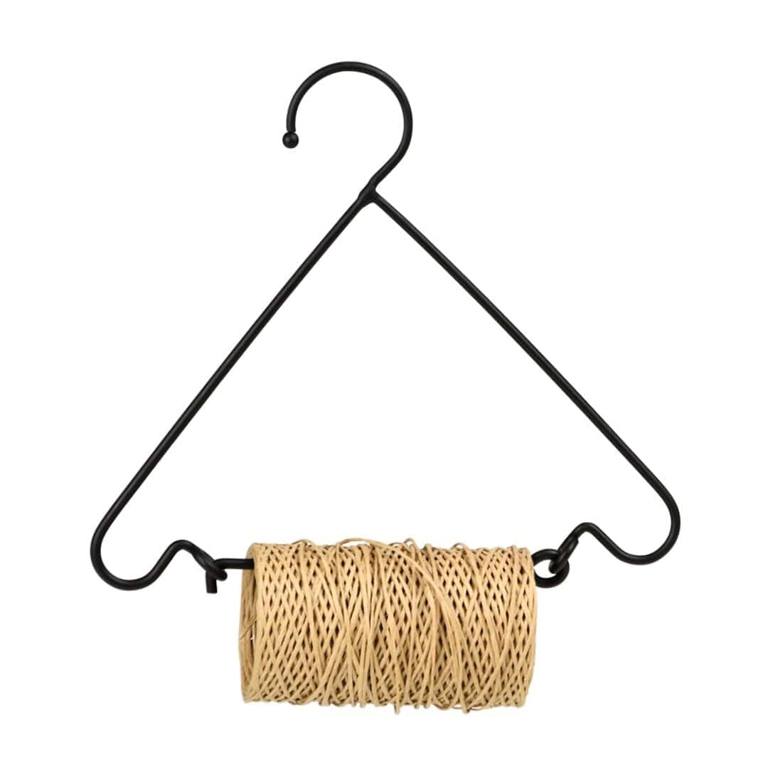 a spool of twine hanging from a hook